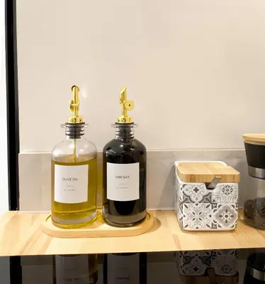 two bottles of oil sitting on a wooden shelf at The Sunshine Apartment in Valencia
