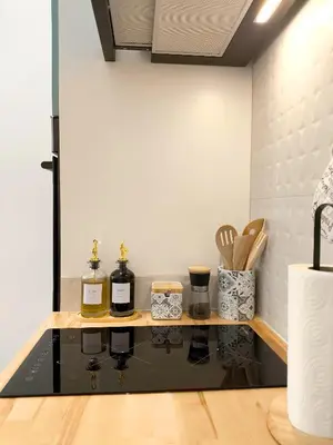 a kitchen with a counter with bottles of wine at The Sunshine Apartment in Valencia