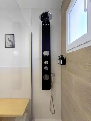 a shower in a bathroom with a shower head at The Sunshine Apartment in Valencia