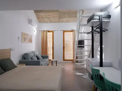 a bedroom with a bed and a living room at Apartment San Pedro 4 in Valencia