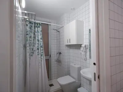 a white bathroom with a toilet and a shower at Apartment San Pedro 4 in Valencia
