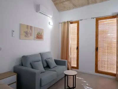 a living room with a blue couch and a table at Apartment San Pedro 4 in Valencia