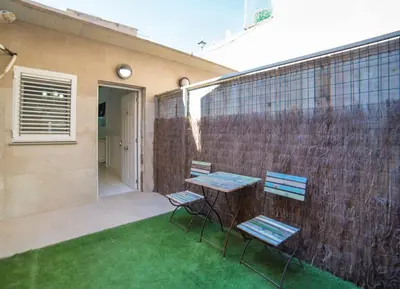 a patio with two chairs and a table and a wall at L'Otelet By Sweet in Valencia