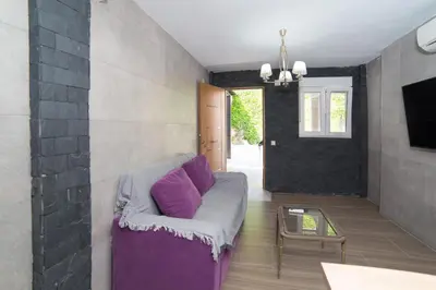 a living room with a purple couch and a table at L'Otelet By Sweet in Valencia