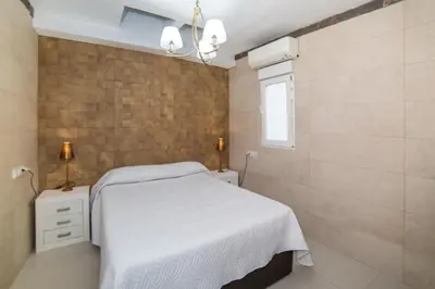 a bedroom with a white bed and a brick wall at L'Otelet By Sweet in Valencia