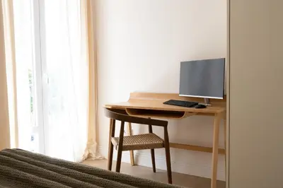 a desk with a computer and a chair in a room at Valencia Boutique Stays - High End Apartment in Ruzafa for long stays in Valencia