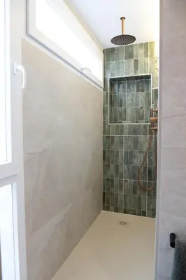 a bathroom with a shower with a glass door at Valencia Boutique Stays - High End Apartment in Ruzafa for long stays in Valencia