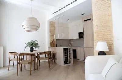 a kitchen and dining room with a table and chairs at Valencia Boutique Stays - High End Apartment in Ruzafa for long stays in Valencia