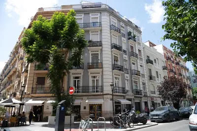 a tall white building with bikes parked in front of it at Valencia Boutique Stays - High End Apartment in Ruzafa for long stays in Valencia