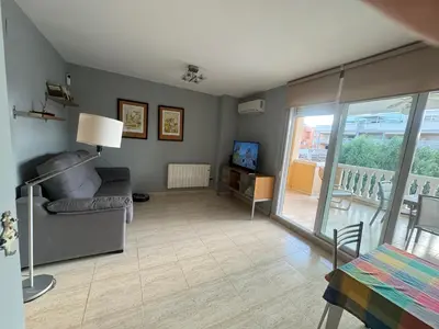 a living room with a couch and a television at Raquel Host Moncofar in Moncófar