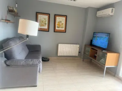 a living room with a couch and a television at Raquel Host Moncofar in Moncófar