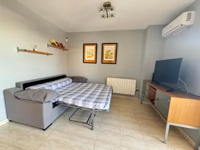 a bedroom with a bed and a flat screen tv at Raquel Host Moncofar in Moncófar