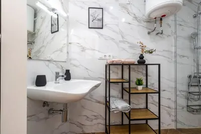 a white bathroom with a sink and a mirror at Estudio tranquilo cerca del Centro in Valencia