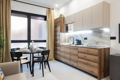 a kitchen and dining room with a table and chairs at FLORIT FLATS - The Maritim Studios in Valencia