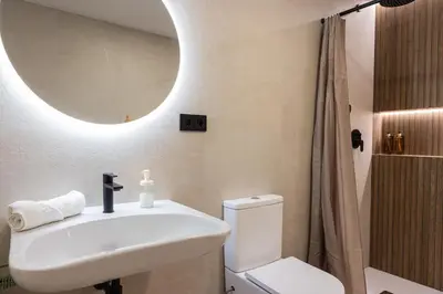 a bathroom with a sink and a toilet and a mirror at FLORIT FLATS - The Maritim Studios in Valencia