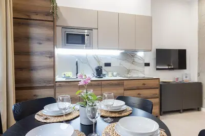 a kitchen with a table with plates and glasses at FLORIT FLATS - The Maritim Studios in Valencia