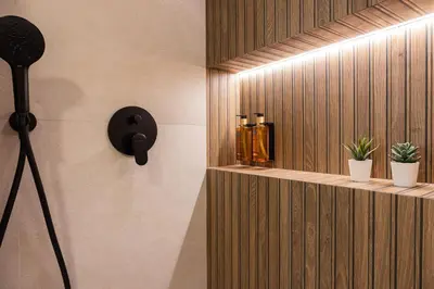 a light on a wall next to a shelf with candles at FLORIT FLATS - The Maritim Studios in Valencia
