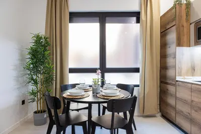 a dining room with a table and chairs and a window at FLORIT FLATS - The Maritim Studios in Valencia