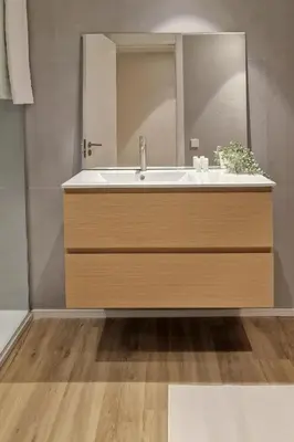 a bathroom with a sink and a mirror at VLC Host - Belgica Apartments in Valencia