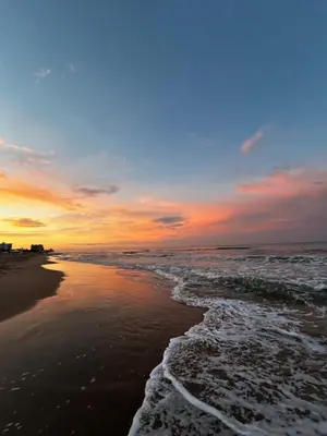 a sunset on the beach with the ocean at Casa La Mar in Mareny Blau