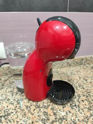 a red appliance sitting on a counter with a brush at FLATS FAMILY APARTAMENTO DE 3 HABITACIONEs in Valencia