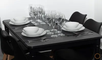 a black table with wine glasses and plates and silverware at FLATS FAMILY APARTAMENTO DE 3 HABITACIONEs in Valencia
