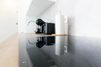 a kitchen with a counter with a sink and a microwave at Global Vacacional, Deslumbrante casa en la playa de Sagunto in Sagunto