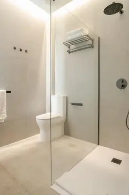 a bathroom with a toilet and a glass shower at Crudo un Loft centrico de 50 m2 in Valencia