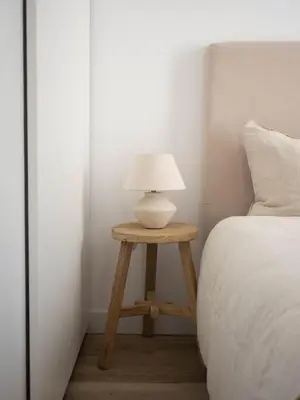 a table with a lamp on it next to a bed at GuestReady – Luminous City Getaway in Valencia