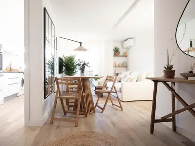 a dining room and living room with a table and chairs at GuestReady – Luminous City Getaway in Valencia
