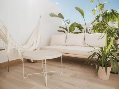 a living room with a white couch and plants at GuestReady – Luminous City Getaway in Valencia