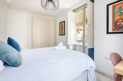 a white bedroom with a white bed and a window at Super Flat 3 rooms 1 toilet Center wifi AC in Valencia