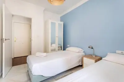 a white bedroom with two beds and a mirror at Super Flat 3 rooms 1 toilet Center wifi AC in Valencia