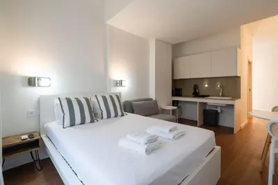 a bedroom with a white bed with towels on it at VLC Host - Vicente Brull in Valencia