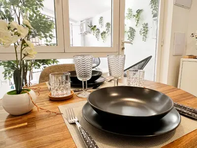 a wooden table with a black plate on top of it at JB22 - Loft Valencia in Valencia