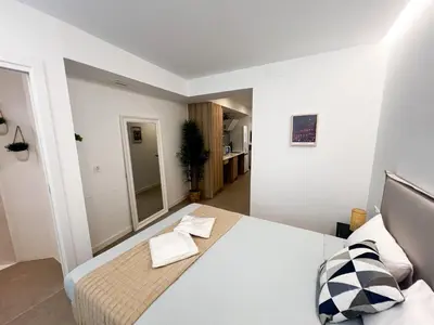 a bedroom with a white bed and a mirror at JB22 - Loft Valencia in Valencia