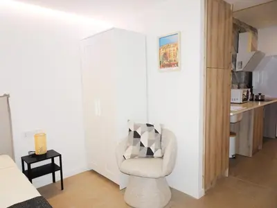 a living room with a chair and a kitchen at JB22 - Loft Valencia in Valencia