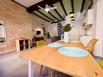 a dining room with a wooden table with chairs at Mediterranean Flat next to the Historic Center in Valencia