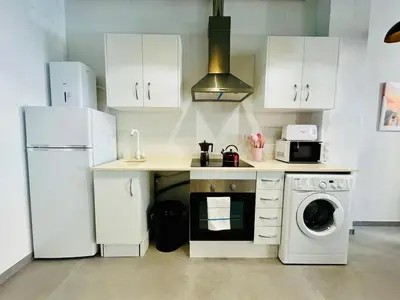 a kitchen with a white refrigerator and a dishwasher at Mediterranean Flat next to the Historic Center in Valencia