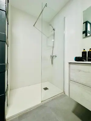 a shower with a glass door in a bathroom at Mediterranean Flat next to the Historic Center in Valencia