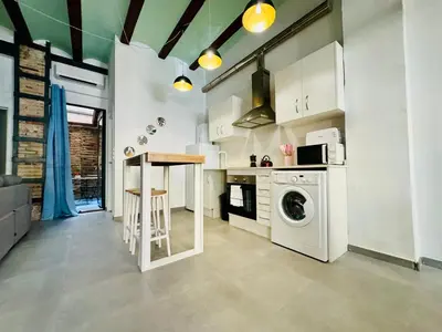 a kitchen with a washing machine and a counter at Mediterranean Flat next to the Historic Center in Valencia