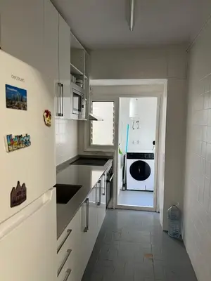 a kitchen with white cabinets and a stove top oven at Aldair in Valencia