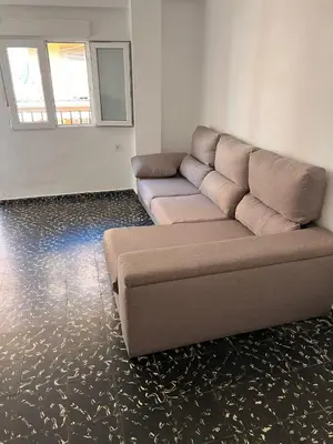 a living room with a couch and a mirror at Aldair in Valencia
