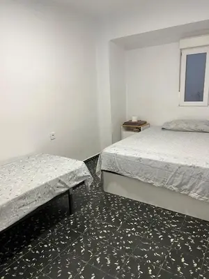 a bedroom with two beds and a window at Aldair in Valencia