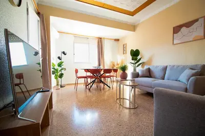 a living room with a couch and a table at Global Vacacional, Vivienda cozy en Puerto de Sagunto in Puerto de Sagunto