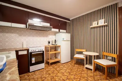a kitchen with a refrigerator and a table and chairs at Global Vacacional, Vivienda cozy en Puerto de Sagunto in Puerto de Sagunto