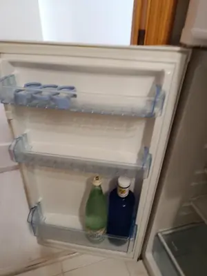 a refrigerator with two bottles of water in it at BRISA DEL MAR en primera línea in Torres-Torres
