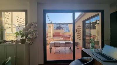 a room with a door to a patio with a table at Modern Flat with Large Terrace in Valencia