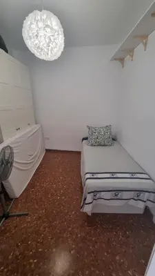 a white room with a bed and a chandelier at Modern Flat with Large Terrace in Valencia