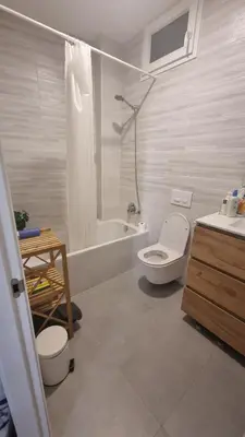 a bathroom with a toilet and a tub and a sink at Modern Flat with Large Terrace in Valencia